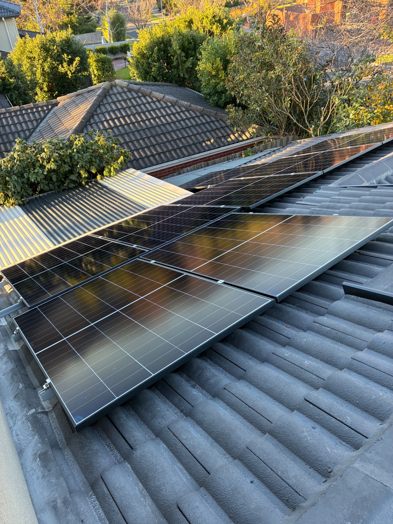 Cleaned rooftop solar panels on a tiled roof in Lysterfield, Victoria — Bluewater Pressure Washing