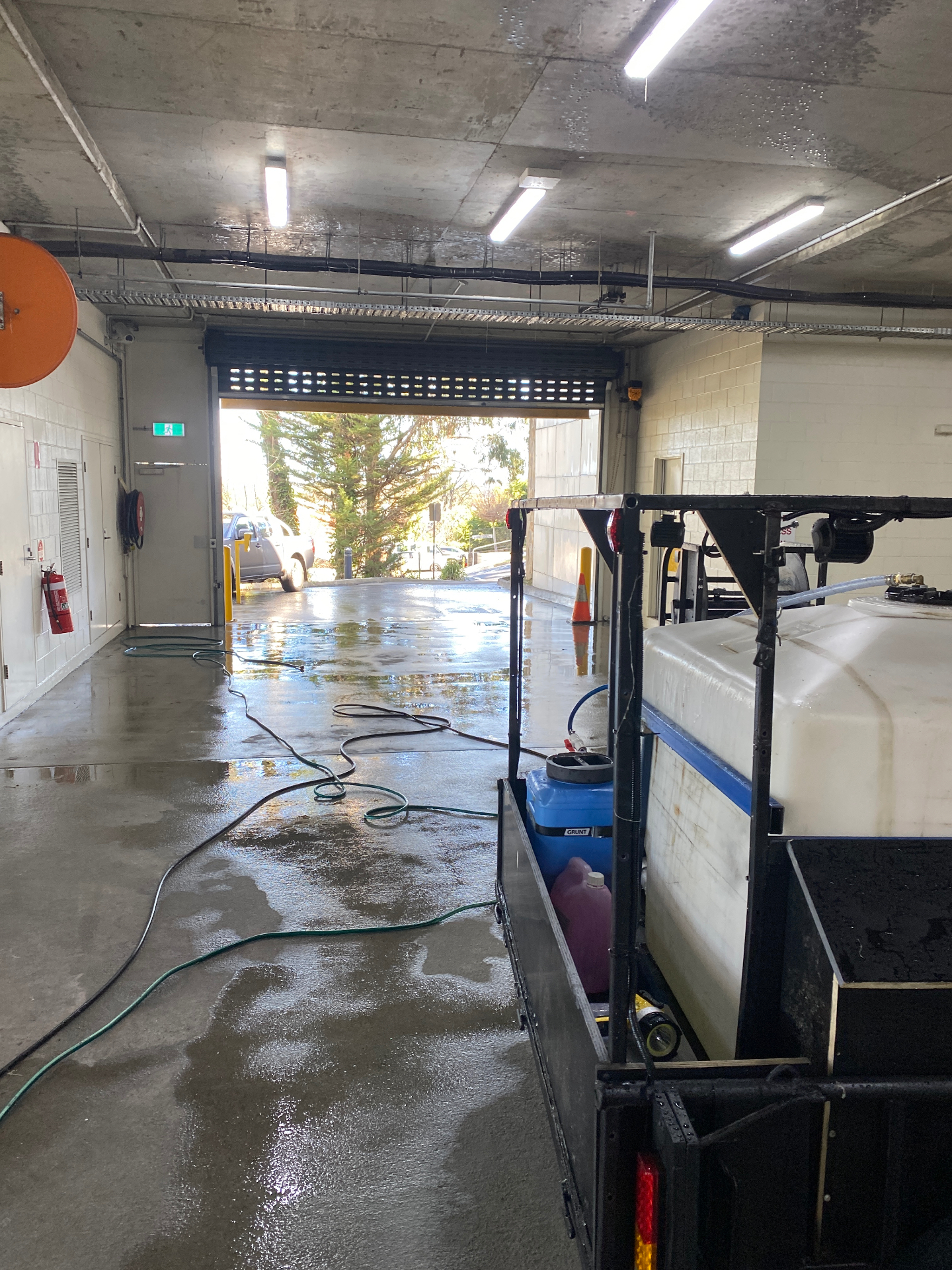 Bluewater pressure washing rig and hoses set up at the carpark roller door in Moorabbin, Victoria — Bluewater Pressure Washing